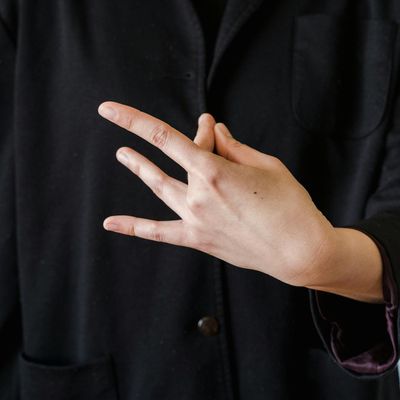 Close-up of hands in a meditative mudra pose.